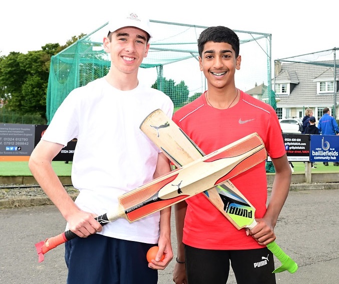 Photograph of 2 young people with cricket bats